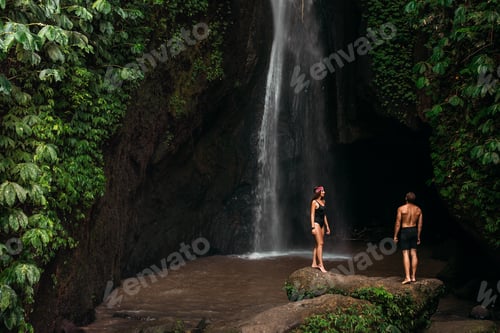 Preview: Couple at a tropical waterfall. The couple travels to the island of Bali in Indonesia