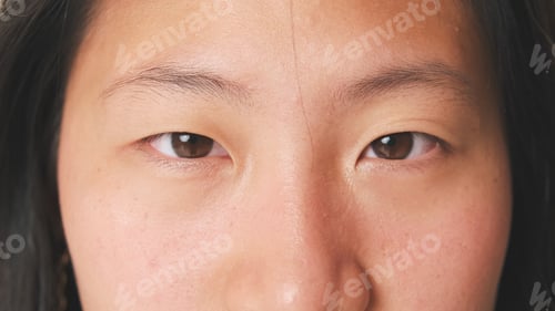 Preview: Close-up of girl's eyes, opens her eyes and looks into the camera