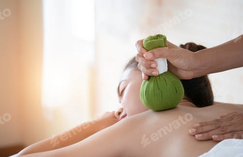 Preview: Woman Receiving Herbal Compress Massage at Spa
