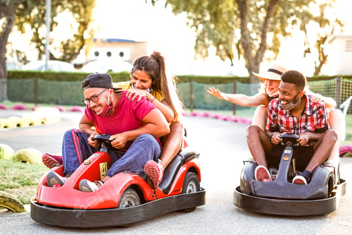 Preview: Group of multiracial friends having fun with go kart