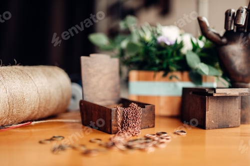 Preview: Needlework, metal rings and wooden box on table