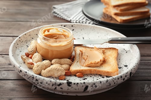 Preview: Jar with creamy peanut butter and toast on plate