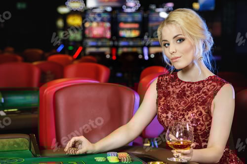 Preview: Young blonde woman playing roulette in the casino