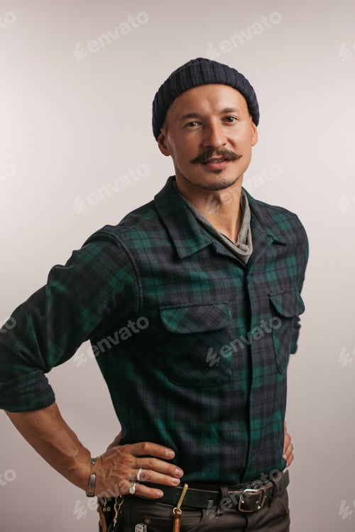 Preview: craftsman standing confidently with arms folded isolated white studio background looking at camera