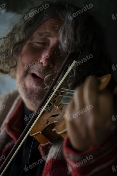 Preview: Elderly man immersed in his music playing a violin