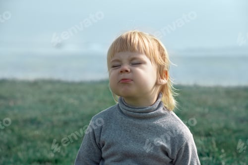 Preview: Child wrinkles face to express dissatisfaction