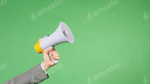 Preview: Hand is hold megaphone and wear grey suit on green screen background.