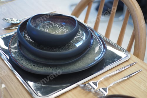 Preview: round bowl or ceramic plate on napkin on wooden table.