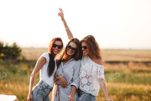 Preview: Three gorgeous young women in sunglasses stand in the field and smiling on a sunny day