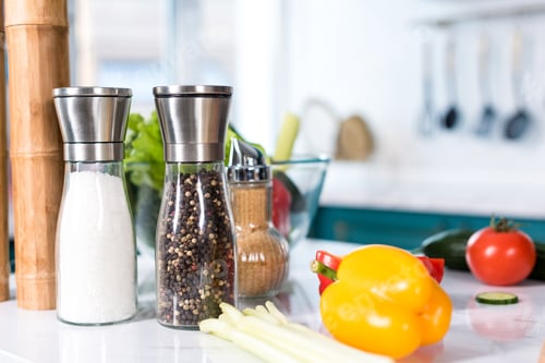 Preview: close-up view of fresh vegetables and spices in containers on kitchen table
