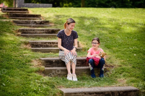 Preview: Mother and Daughter Sitting on Steps in Park