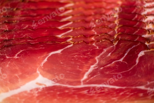 Preview: Sliced italian prosciutto background. Top view, copy space. Prosciutto texture close up