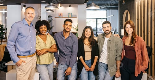 Preview: Diverse business team smiling at camera in modern office