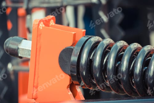 Preview: Hard black spring made of steel. Part of big industrial or agricultural machine