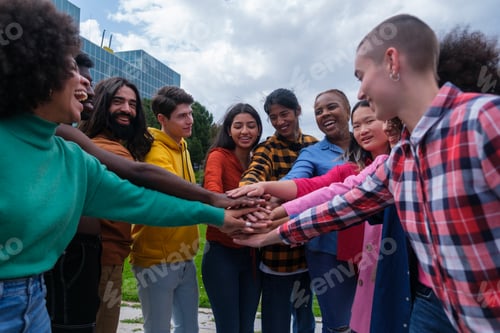 Preview: Group of ethnically diverse young people joining hands