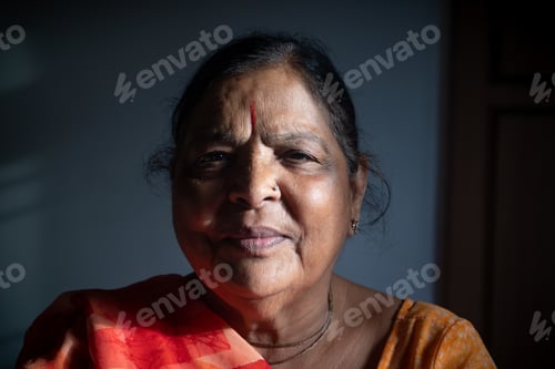 Preview: Closeup portrait of an old Asian woman in sunlight and shadow