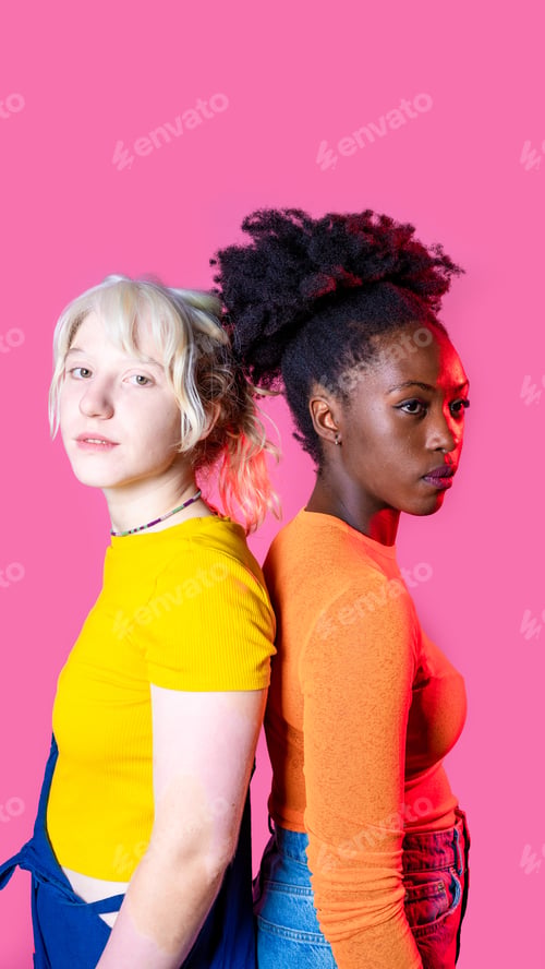 Preview: Two young diverse multicultural caucasian and black women best friends posing isolated background