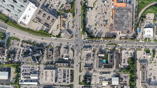 Preview: Aerial view of a busy urban intersection with commercial buildings and parking lots , Canada