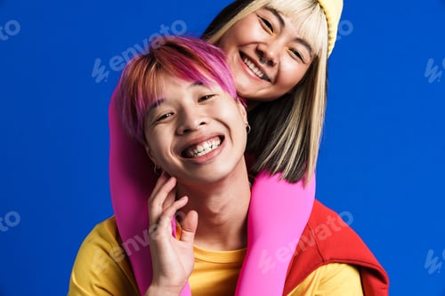 Preview: Asian couple with multicolored hair hugging while smiling together