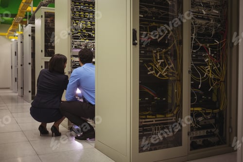 Preview: Technicians Analyzing Server In Server Room