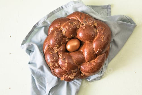 Preview: Tsoureki traditional baked Greek Easter sweet bread, with a boiled red dyed egg in the middle