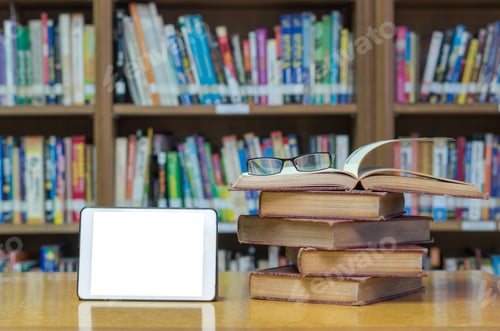 Preview: old book on the desk in library with tablet and glasses
