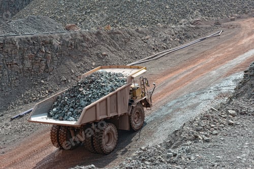 Preview: dumper truck with loaded stones driving along in a quarry. mining industry.