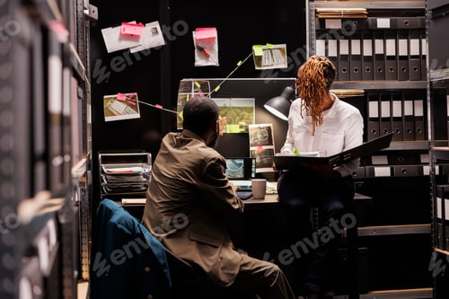 Preview: Detective partners analyzing surveillance photos hanging on evidence board
