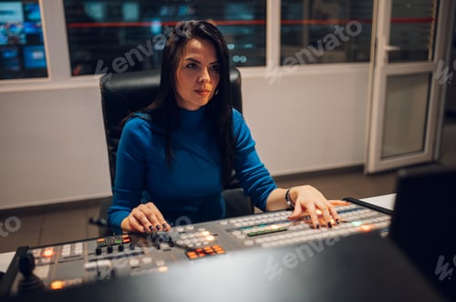 Preview: Middle aged woman using equipment in control room on a tv station