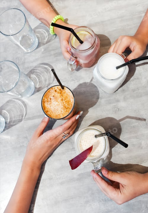 Preview: Crop family holding fresh drinks over table