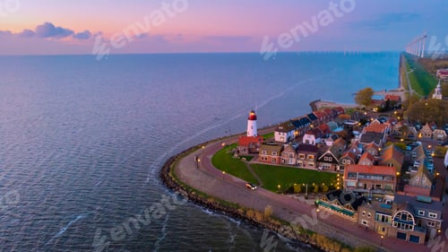 Preview: Urk Flevoland Netherlands sunset at the lighthouse and harbor of Urk Holland. Fishing village Urk