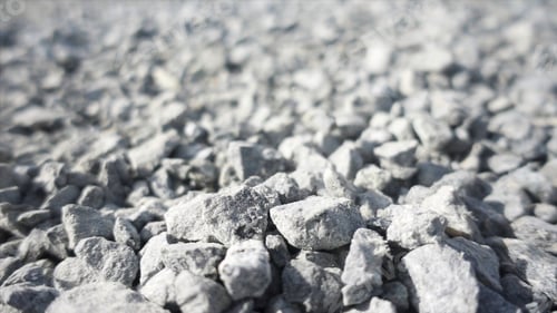 Preview: Background of gray granite gravel under the bright sun. Stock footage. Close up of white stones