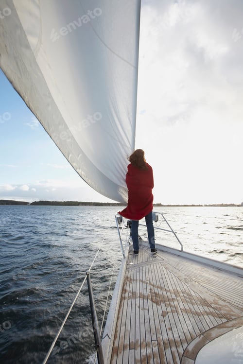 Preview: Woman standing by sail on yacht