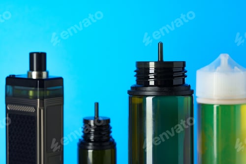 Preview: Black electronic cigarettes liquid bottles on blue background