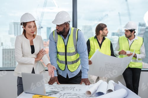 Preview: Engineers meet in the office to work on an architectural project as a team.