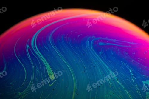 Preview: Abstract of a soap bubble. A mix of blue, green, pink and magenta with black background.