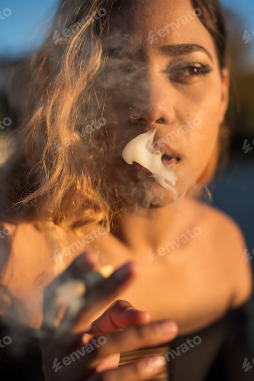 Preview: Close up portrait of woman smoking a cannabis joint