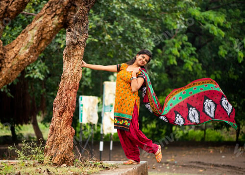 Preview: Young girl near tree trunk and she enjoying fresh air outdoors