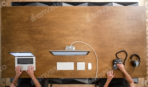 Preview: Work desk, male hands working on laptop on wooden table.