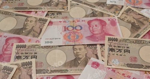 Preview: Stack of Chinese RMB and Japanese Yen banknote