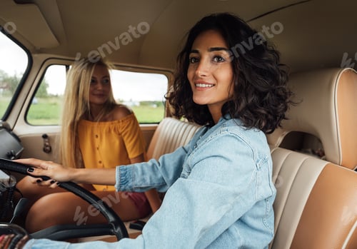 Preview: Women friends enjoying on a road trip.