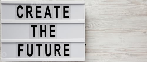 Preview: 'Create the future' word on modern board on a white wooden background, top view.