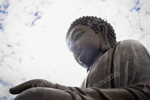 Preview: a picture of a Buddha statue sitting under a cloudy sky on a sunny day
