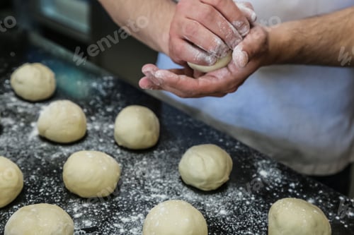 Preview: man are forming dough bolls flour side view