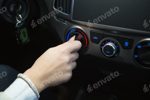 Preview: driver turning car air conditioner knob