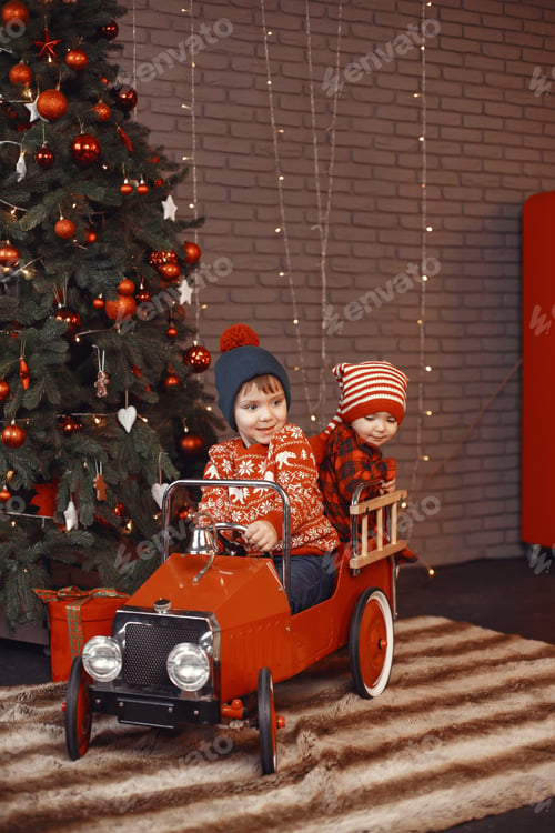 Preview: Cutte little kids at home near christmas decorations