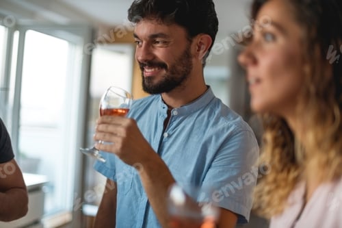 Preview: Smiling man holding glass of wine