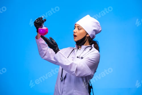 Preview: Isolated nurse in hand and face mask holds chemical flask and gets scared