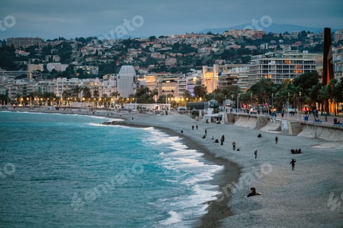 Preview: Nice city promenade in the evening at blue hour, buildings with mountains