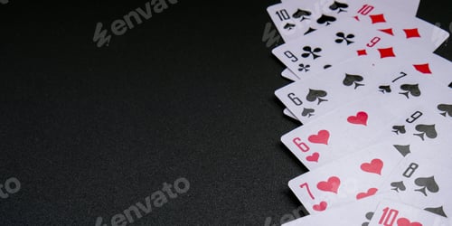 Preview: Playing cards on black background with copy space. Stay home leisure activity for family and friends